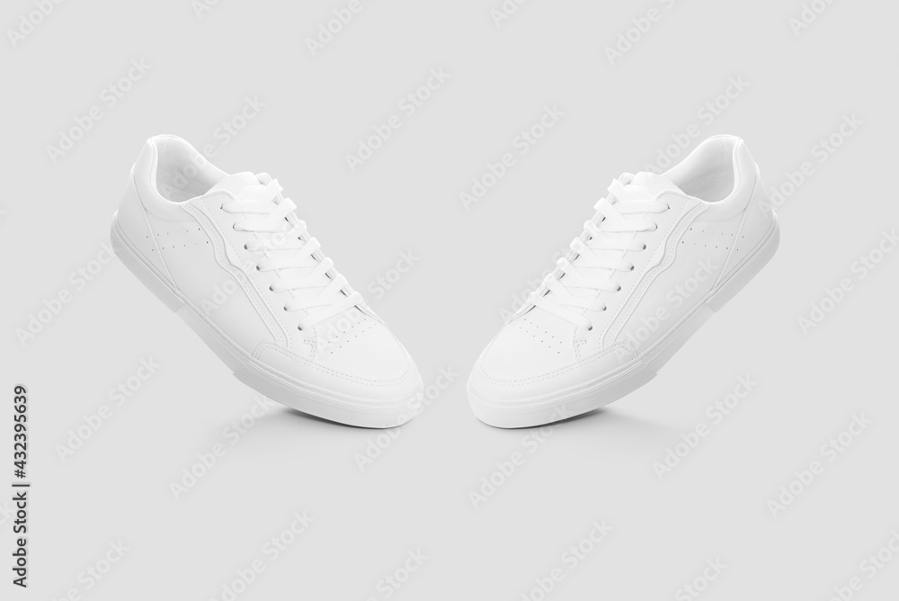 Mockup of a pair of sneakers isolated against a plain background Mockup of a pair of sneakers isolated against a plain background