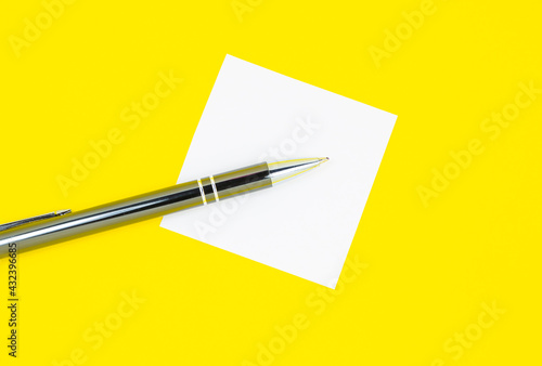 Blank white To Do List Sticker with pen. Searching information on the Internet..Close up of reminder note paper on the yellow background. Copy space. Minimalism, original and creative.