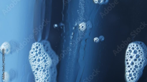 macro photography of soap bubbles the window cleaning chemistry flows down the glass beautifully reflecting