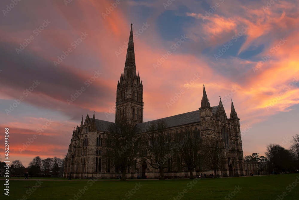 The silhouette of Salisbury Cathedral at sunset in Wiltshire, UK