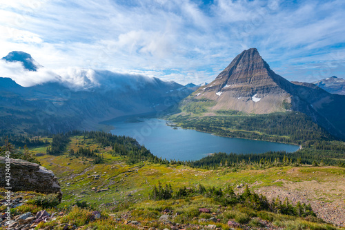 Hidden Lake and pyramid-shaped Bearhat Mountain in Glacier National Park, Montana, USA. Early morning light and scattered clouds above alpine valley in American Rockies. Hiking in Rocky Mountains photo