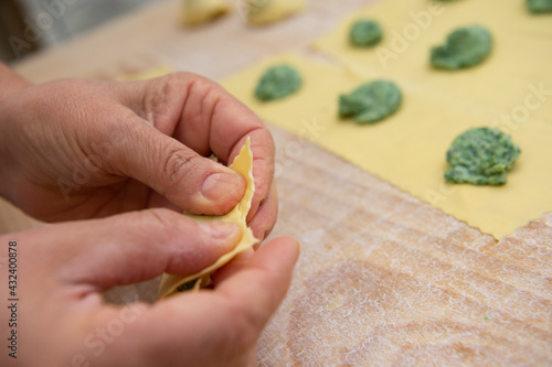 pansoti al prebuggiun is the name of this typical Ligurian stuffed pasta similar to a large tortellino with wild herbs inside called prebuggiun photo