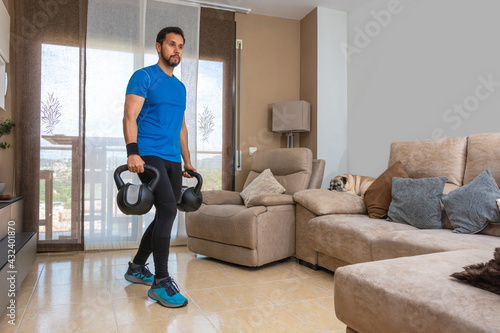 Latin man performing a cross fit workout at home