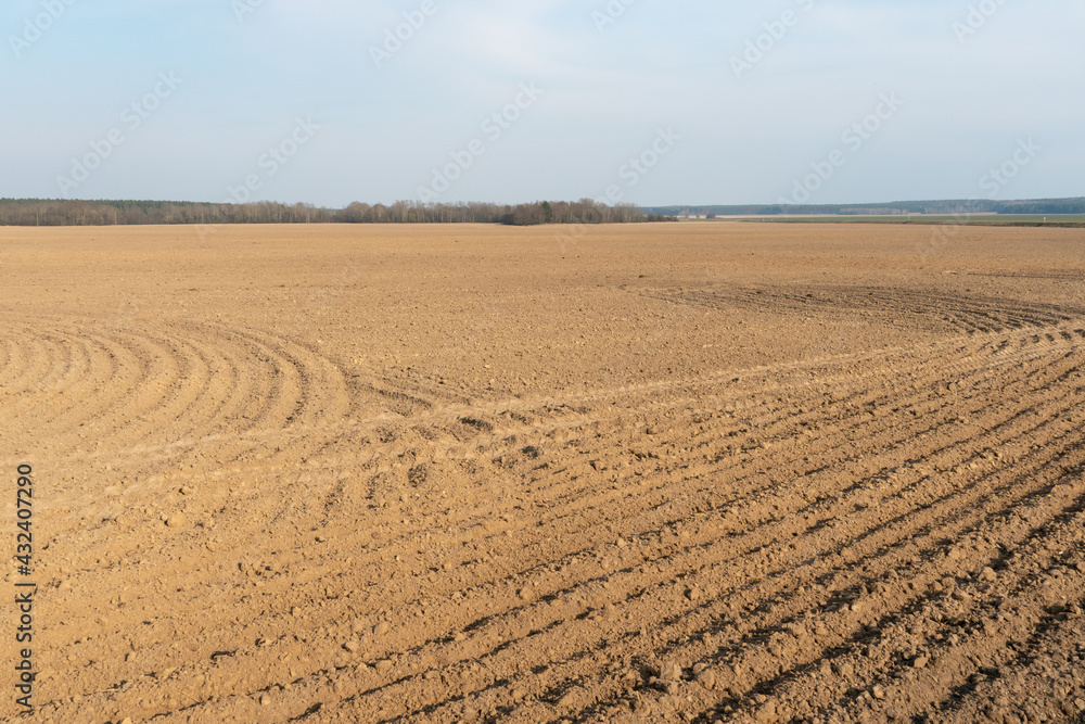 a freshly plowed field before sowing grain crops, wheat and barley. Preparation of the soil for sowing seeds. The sowing season. a freshly plowed field before sowing grain crops, wheat and barley. Preparation of the soil for sowing seeds. The sowing season.