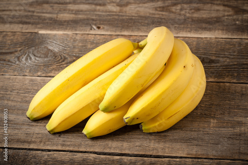 Fresh bunch of bananas on wooden table