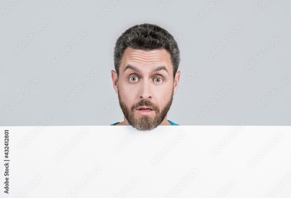 amazed male behind black paper. surprised man with copy space for advertisement. amazed male behind black paper. surprised man with copy space for advertisement.