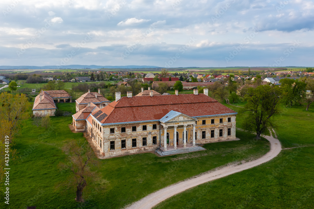 Aerial view about abandoned Cziraky Castle with cloudy sky at the background.