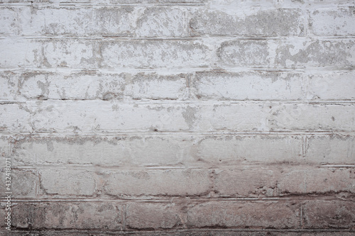 Brown brick wall with scratches, cracks, dust, crevices, roughness. Can be used as a poster or background for design.