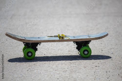 Kids skate with green wheels on the street, transport for sports 