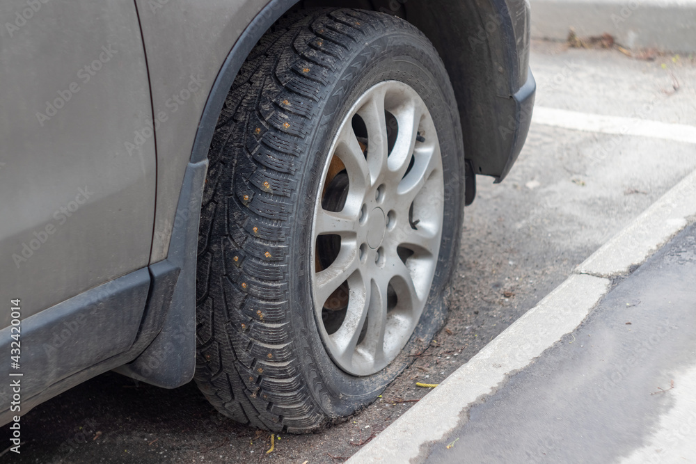 broken car wheel close-up. rubber tire with spikes on the wheel broken car wheel close-up. rubber tire with spikes on the wheel