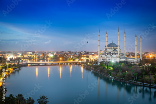Sabanci Central Mosque, Old Clock Tower and Stone Bridge in Adana, city of Turkey. Adana City with mosque minarets in front of Seyhan river. © Suzi