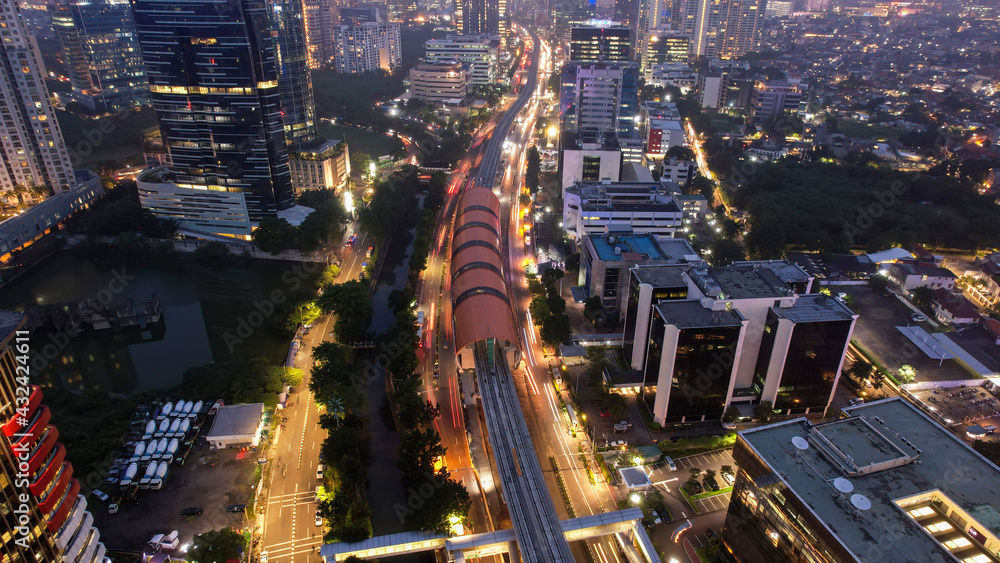 Naklejka premium Aerial view of highway intersection and buildings in the city of Jakarta at night and noise cloud with Jakarta cityscape. Jakarta, Indonesia, May 8, 2021