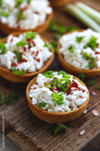 Selective focus. Macro. Tartlets with cottage cheese and herbs. Healthy snack. The keto diet.