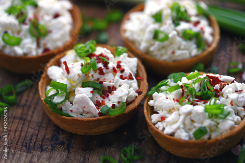 Selective focus. Macro. Tartlets with cottage cheese and herbs. Healthy snack. The keto diet.