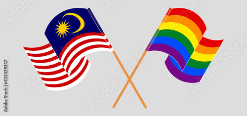 Crossed and waving flags of Malaysia and LGBTQ