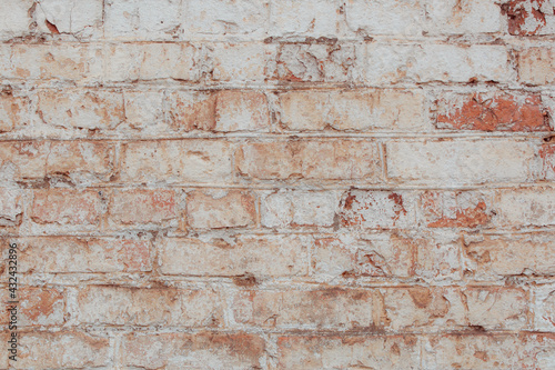 An old brick wall with natural defects. High resolution white brick wall texture. Lots of scuffs, chips and scratches.