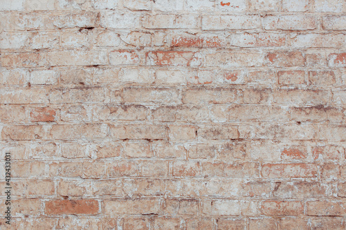 An old brick wall with natural defects. High resolution white brick wall texture. Lots of scuffs, chips and scratches.
