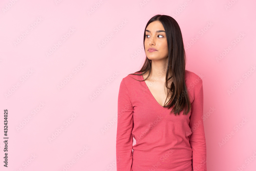 Young caucasian woman over isolated background making doubts gesture looking side Young caucasian woman over isolated background making doubts gesture looking side