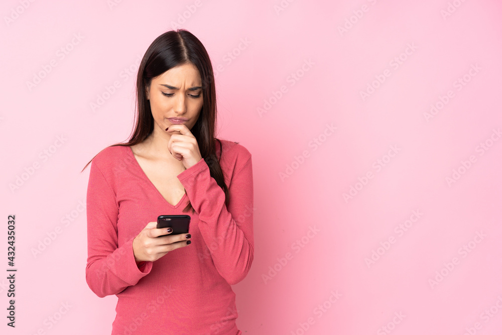 Young caucasian woman over isolated background thinking and sending a message Young caucasian woman over isolated background thinking and sending a message