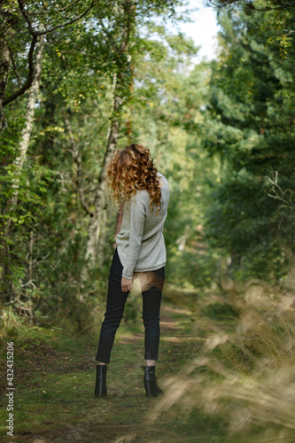 Beautiful women model relaxing in nature, forest. Long blond hair and stylish cozy clothes © Svetlana Batura