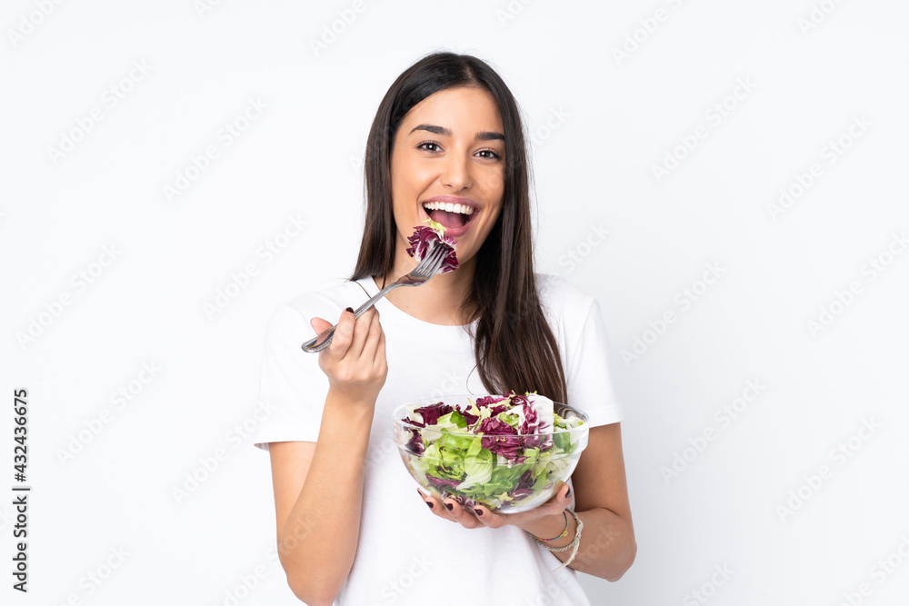 Young woman with salad isolated on white background Young woman with salad isolated on white background