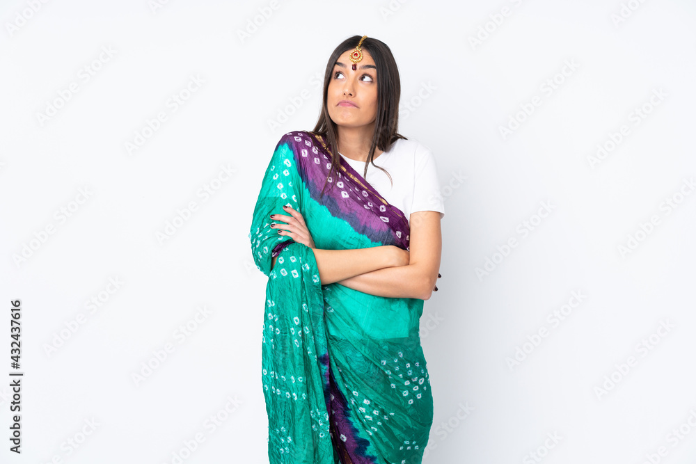 Young Indian woman isolated on white background making doubts gesture while lifting the shoulders Young Indian woman isolated on white background making doubts gesture while lifting the shoulders