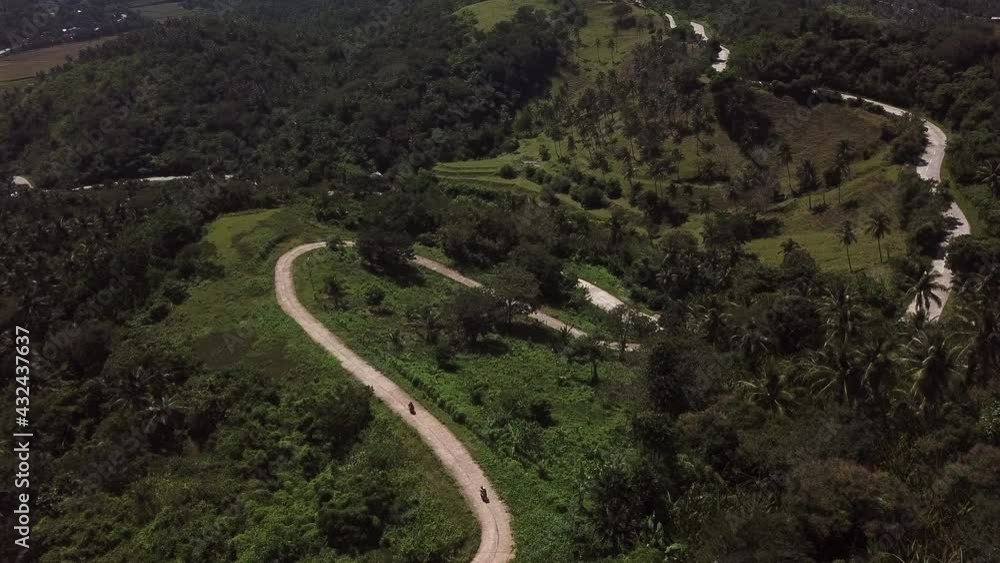 Aerial Shot Of People Riding Motor Vehicles On Winding Road - Catanduanes, Philippines Aerial Shot Of People Riding Motor Vehicles On Winding Road - Catanduanes, Philippines