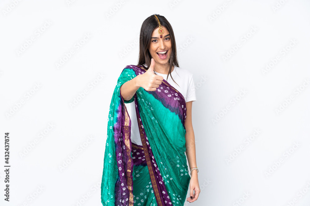 Young Indian woman isolated on white background with thumbs up because something good has happened Young Indian woman isolated on white background with thumbs up because something good has happened
