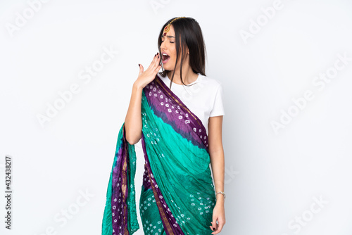 Young Indian woman isolated on white background yawning and covering wide open mouth with hand