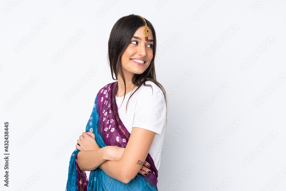 Young Indian woman isolated on white background with arms crossed and happy Young Indian woman isolated on white background with arms crossed and happy