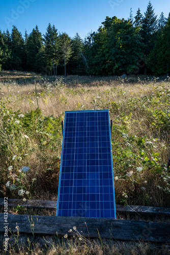 A solar panel charges in the sunshine on an off-grid island photo