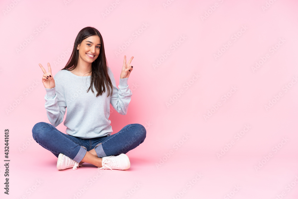 Young caucasian woman isolated on pink background showing victory sign with both hands Young caucasian woman isolated on pink background showing victory sign with both hands