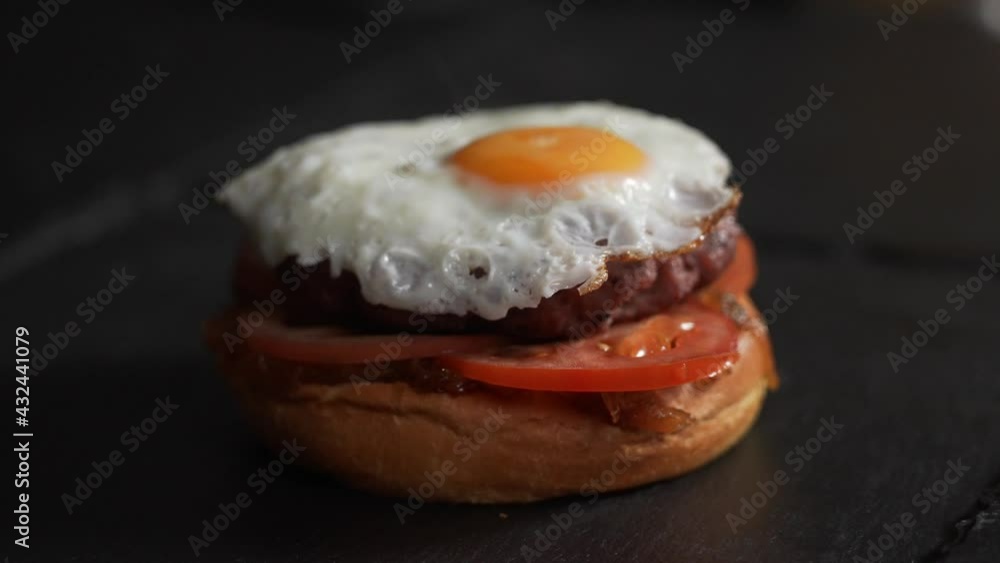 Close up and macro shot of a tasty and juicy egg burger. Gourmet restaurant advertising shot. Close up and macro shot of a tasty and juicy egg burger. Gourmet restaurant advertising shot.