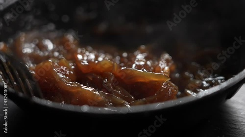 Cooking juicy and tasty caramelized onion to make a burger. Gourmet restaurant food in slow motion. photo