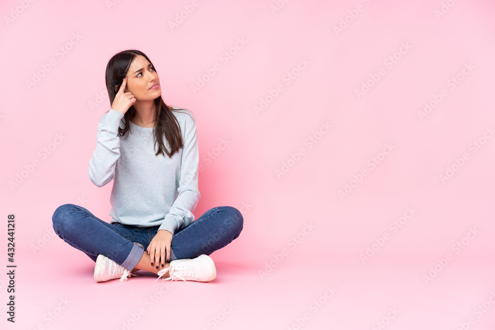 Young caucasian woman isolated on pink background making the gesture of madness putting finger on the head Young caucasian woman isolated on pink background making the gesture of madness putting finger on the head