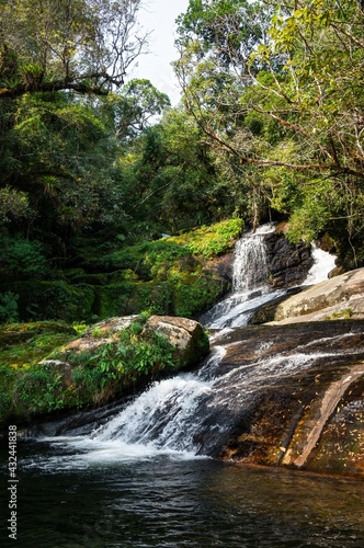 Fototapeta Naklejka Na Ścianę i Meble -  The Ipiranguinha waterfall forming a natural pool right below in the middle of dense and beautiful Serra do Mar (Sea Ridge) forest in Cunha, Sao Paulo - Brazil.