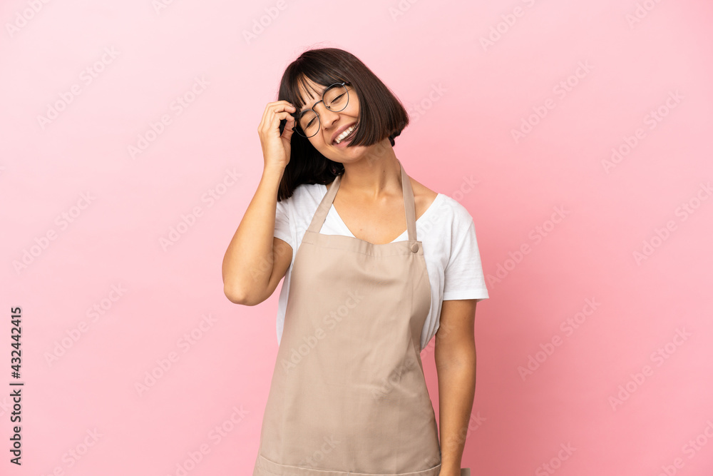 Restaurant waiter over isolated pink background smiling a lot