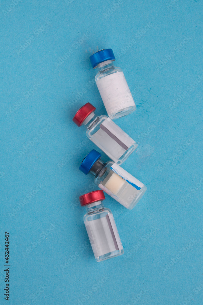 bottles with ampoules of vaccine on a light background bottles with ampoules of vaccine on a light background