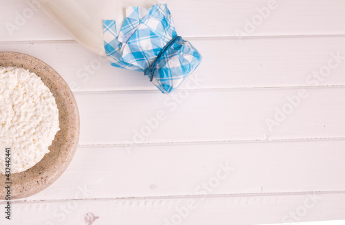 bottle of milk and sour cream on a light background