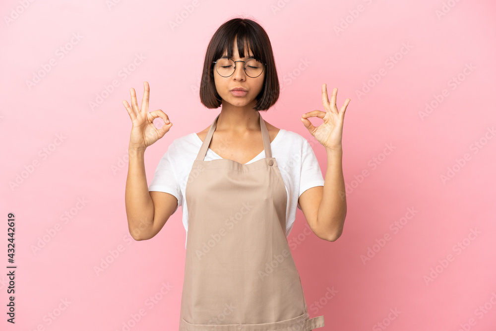 Restaurant waiter over isolated pink background in zen pose Restaurant waiter over isolated pink background in zen pose