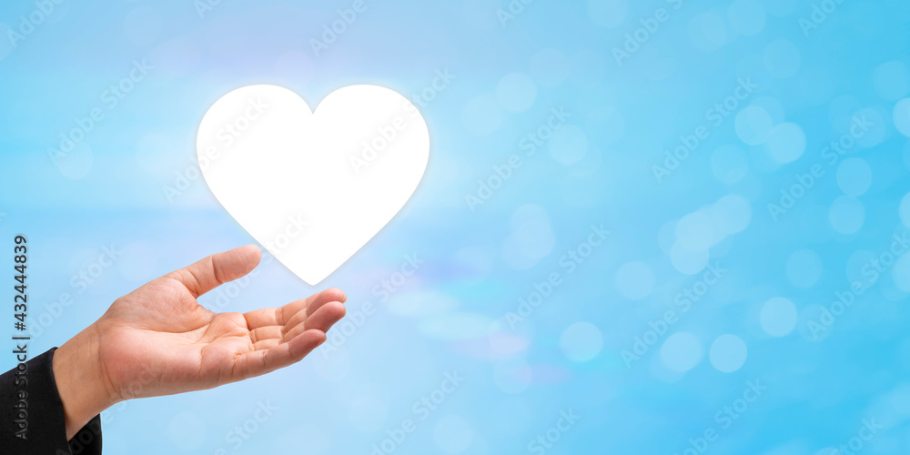 Businessman holding digital image of Heart with care, Concept for after sales, Smart services, services with care , Health Insurance. Businessman holding digital image of Heart with care, Concept for after sales, Smart services, services with care , Health Insurance.