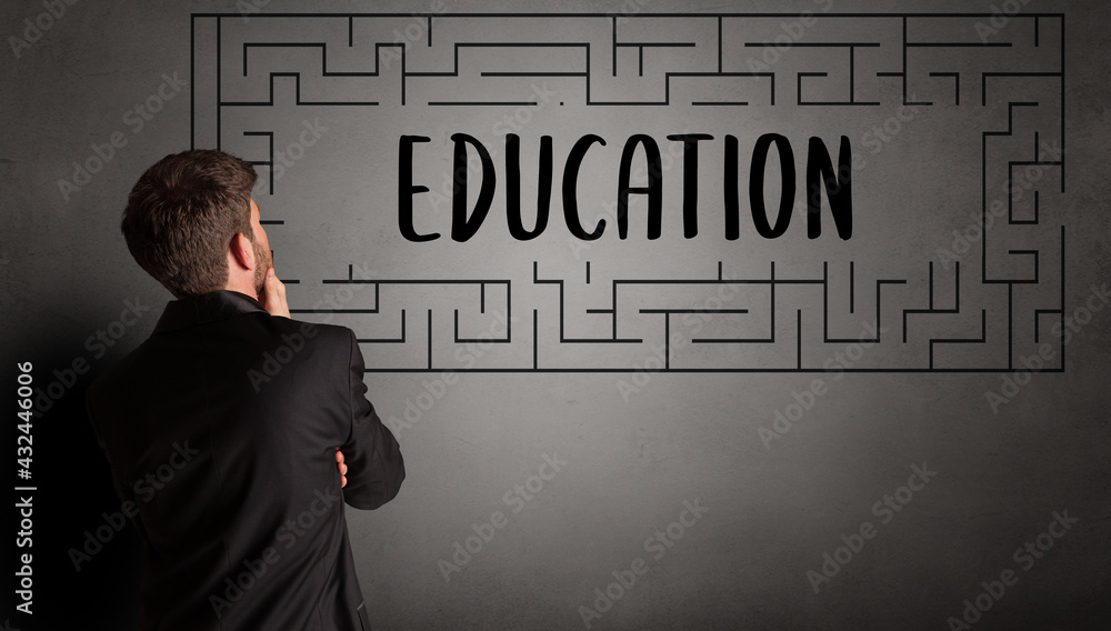 Young businessman drawing maze concept Young businessman drawing maze concept