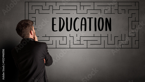 Young businessman drawing maze concept