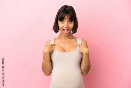 Young pregnant woman over isolated pink background with surprise facial expression