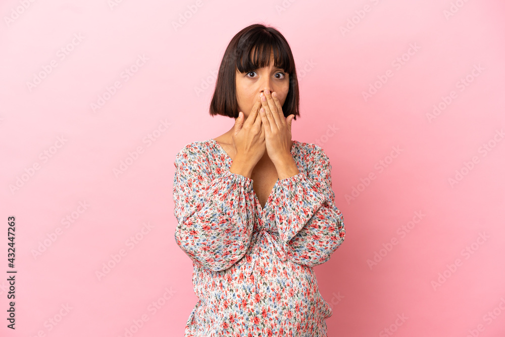 Young pregnant woman over isolated pink background covering mouth with hands Young pregnant woman over isolated pink background covering mouth with hands