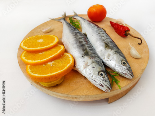 Fresh Seer Fish,King Fish decorated with herbs and vegetables on a wooden pad,Selective Focus.