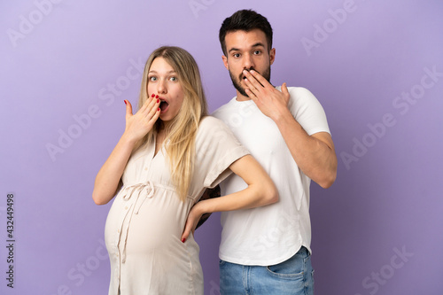 Young couple pregnant and doing surprise gesture
