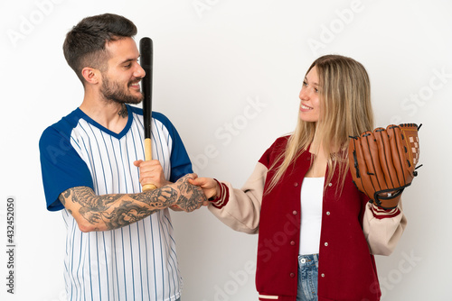 Sticker Couple playing baseball over isolated white background handshaking after good de