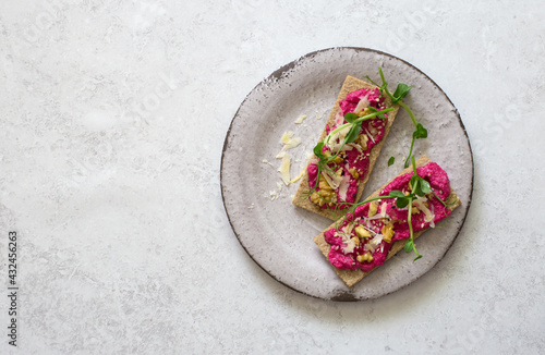 Dietary toasts with beetroot hummus, walnuts and parmesan cheese
