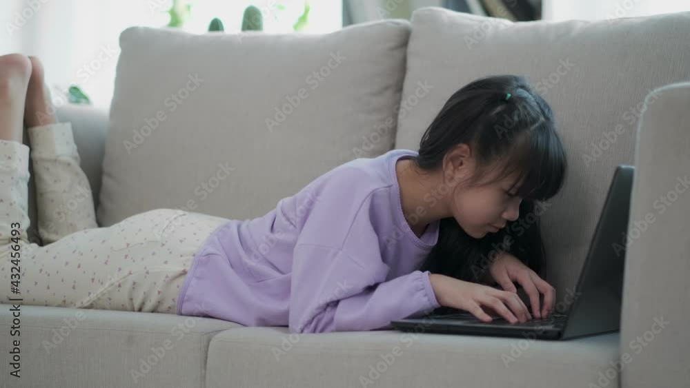 Teenager girl busy to learning looking a screen laptop And type the keyboard during a social distance after coronavirus crisis. online learning at home and new normal concept. Teenager girl busy to learning looking a screen laptop And type the keyboard during a social distance after coronavirus crisis. online learning at home and new normal concept.